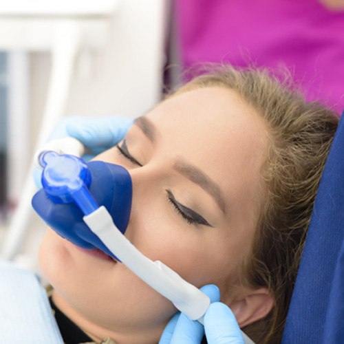 Woman relaxing in dental examination chair with nitrous oxide sedation